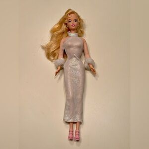 A barbie wearing Mattel 2001 Holiday Excitement Barbie doll dress